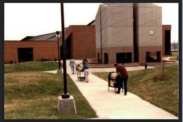 Photo of volunteers moving books to Kisber Library