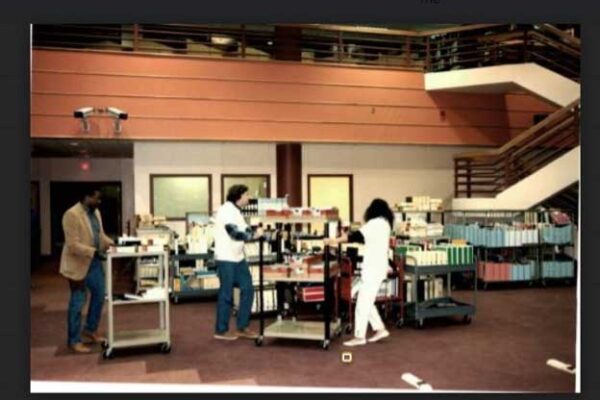 Photo of volunteers moving books to Kisber Library