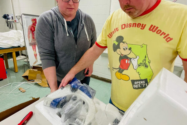 Photo of Perl Cohn High School Students setting up lab