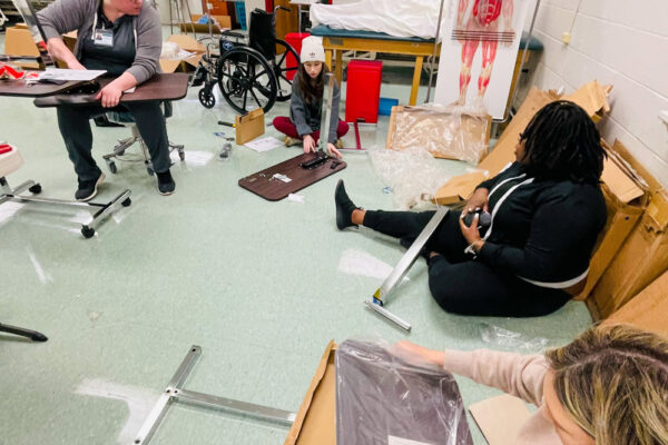 Photo of Perl Cohn High School Students setting up lab