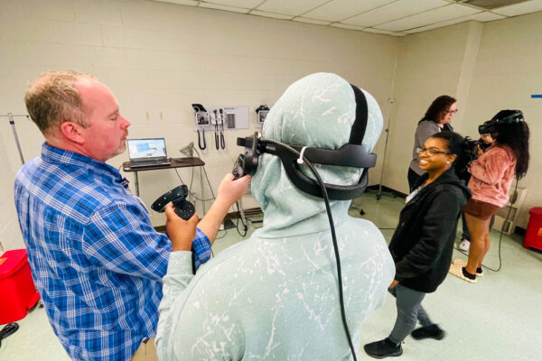 Photo of Perl Cohn High School Students experiencing Periop Sim VR technology